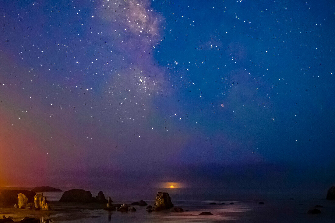 USA, Oregon, Bandon Beach. Lunar eclipse and Milky Way at night.