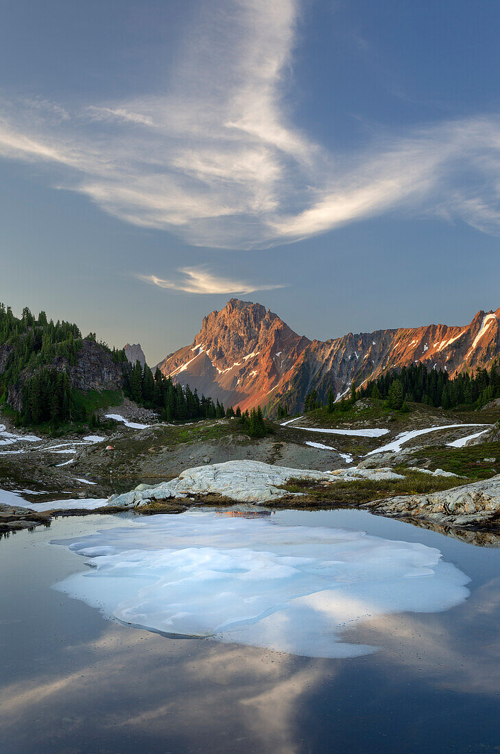 Partially thawed tarn, Yellow Aster Butte Basin. American Border Peak is in the distance. Mount Baker Wilderness, North Cascades, Washington State