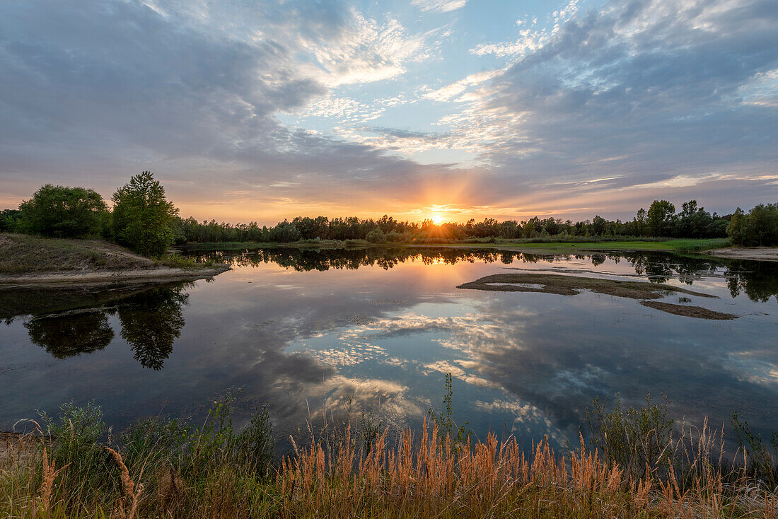 Sunset, clouds are reflected in a gravel pit, Hohenwarthe, Saxony-Anhalt, Germany