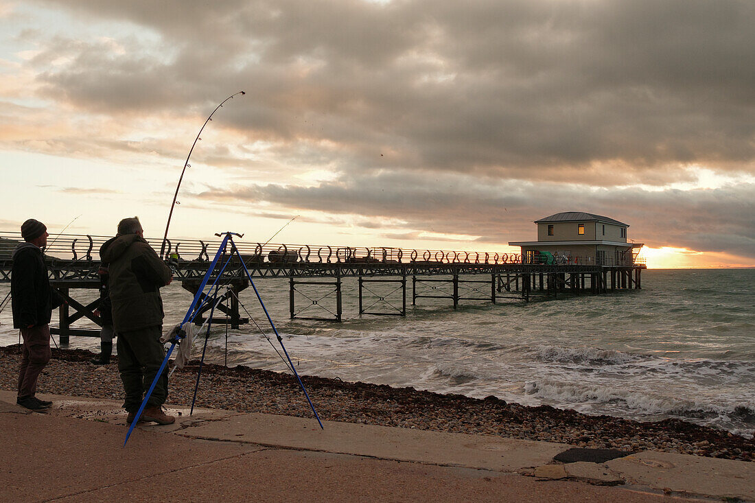 Evening mood at Totland Pier in Freshwater, Isle of Wight, with anglers