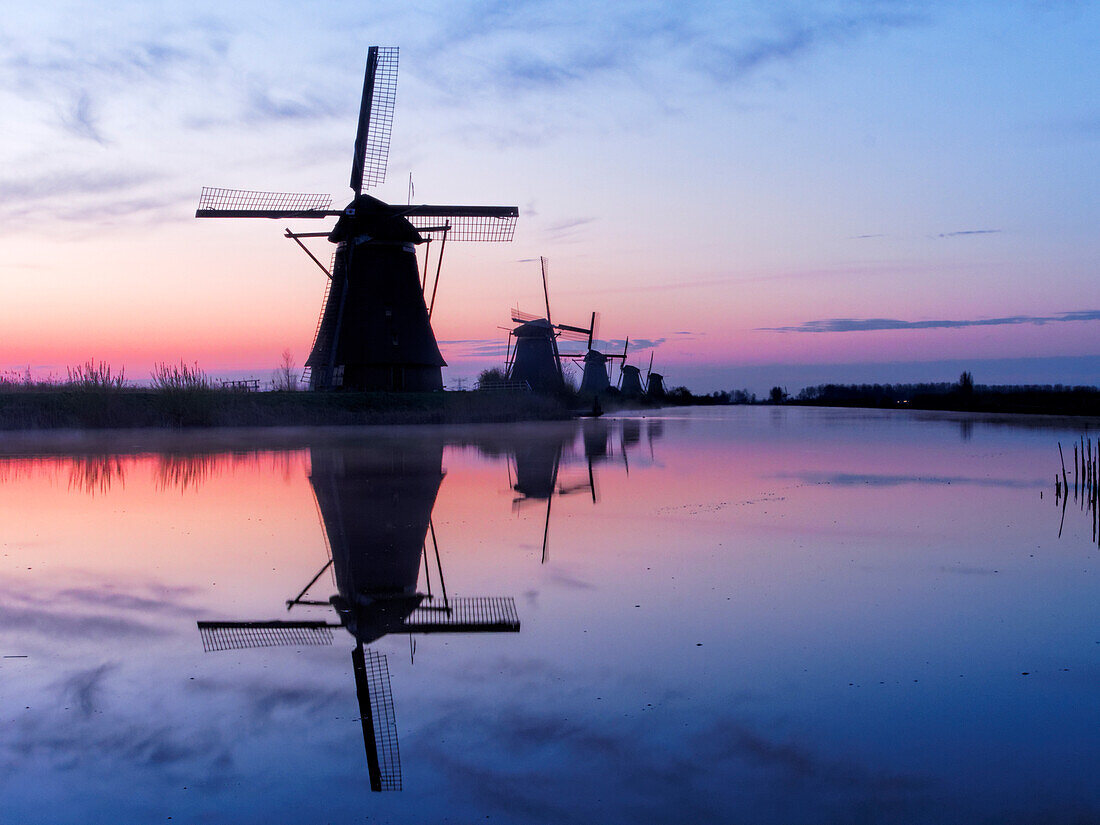 Netherlands, Kinderdijk, Windmills at Sunrise along the canals of Kinderdijk