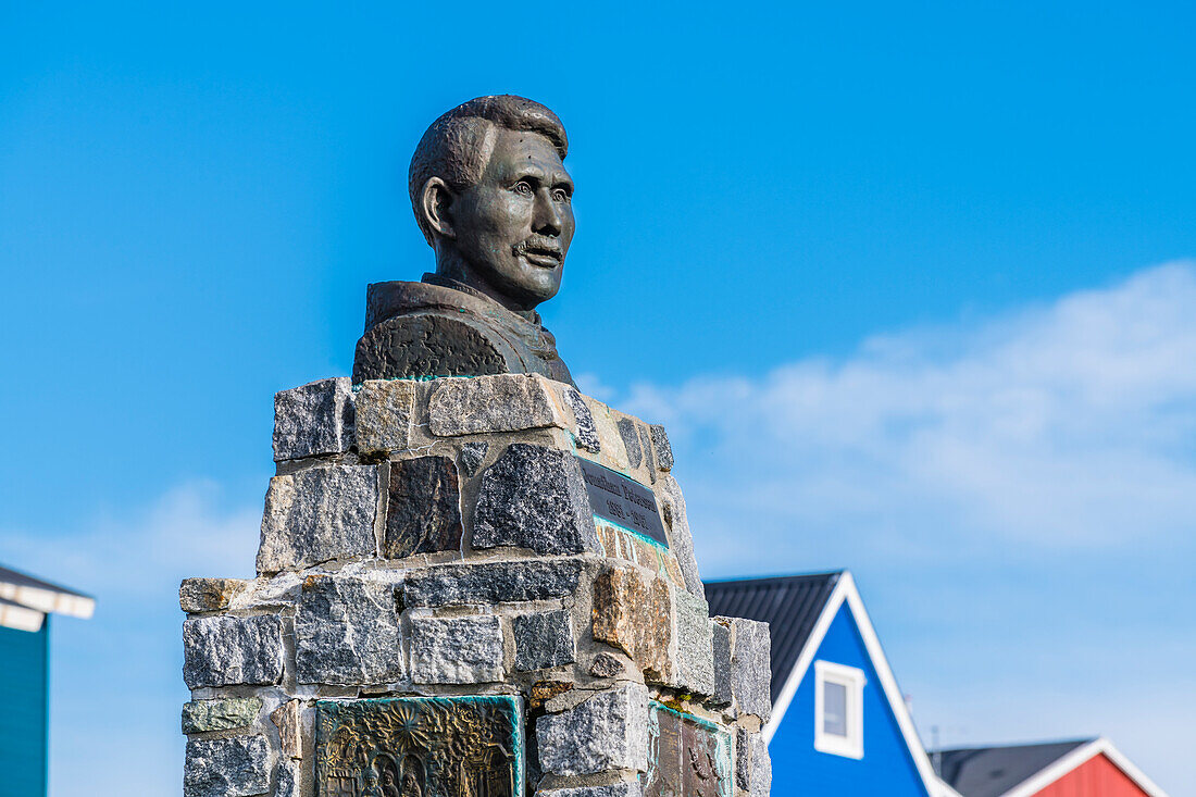 Monument to Jonathan Petersen in front of the Church of the Redeemer, residential houses in the background, Nuuk, Greenland
