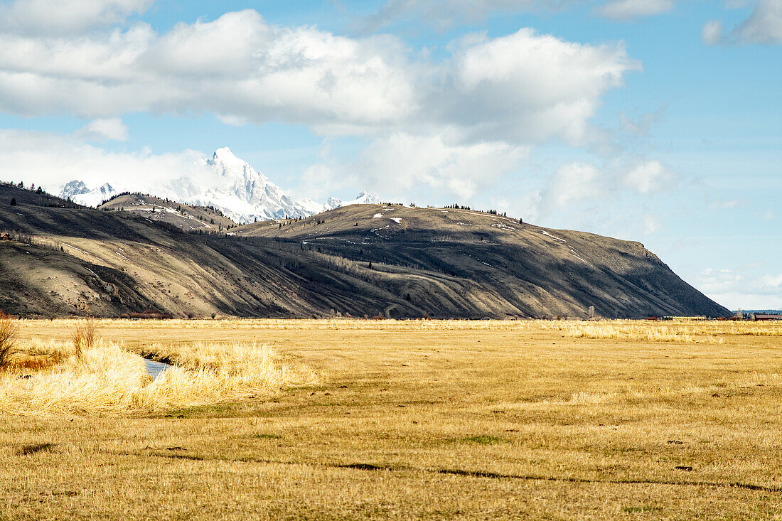 Wolkengefiltertes Sonnenlicht ziert die Außenbezirke der Grand-Teton-Bergkette, Wyoming, USA