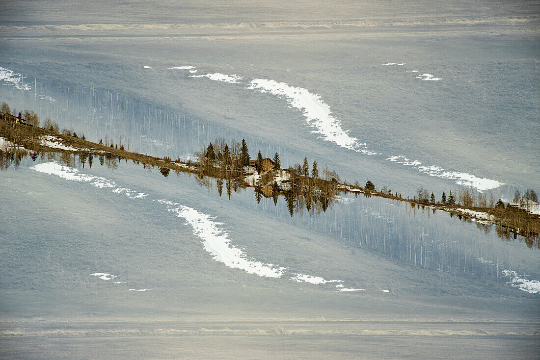Wooden cabin on a hilltop near Grand Teton mountain range