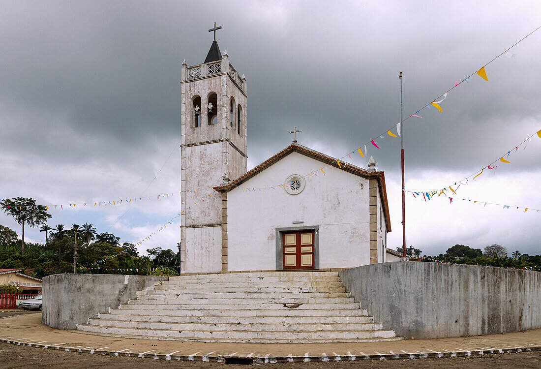 Igreja de Santíssima Trindade church under a dark cloudy sky in Trindade on the island of São Tomé in West Africa