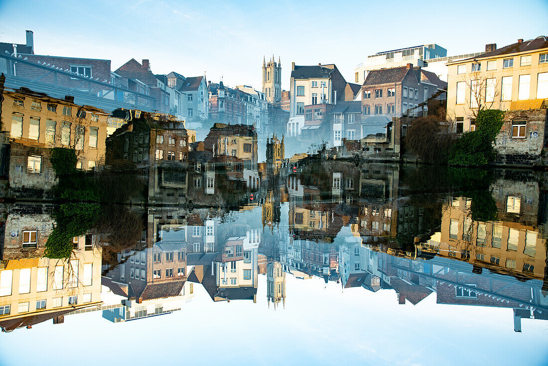Double exposure photo of St Bavo's cathedral reflected in water in Gent, Belgium