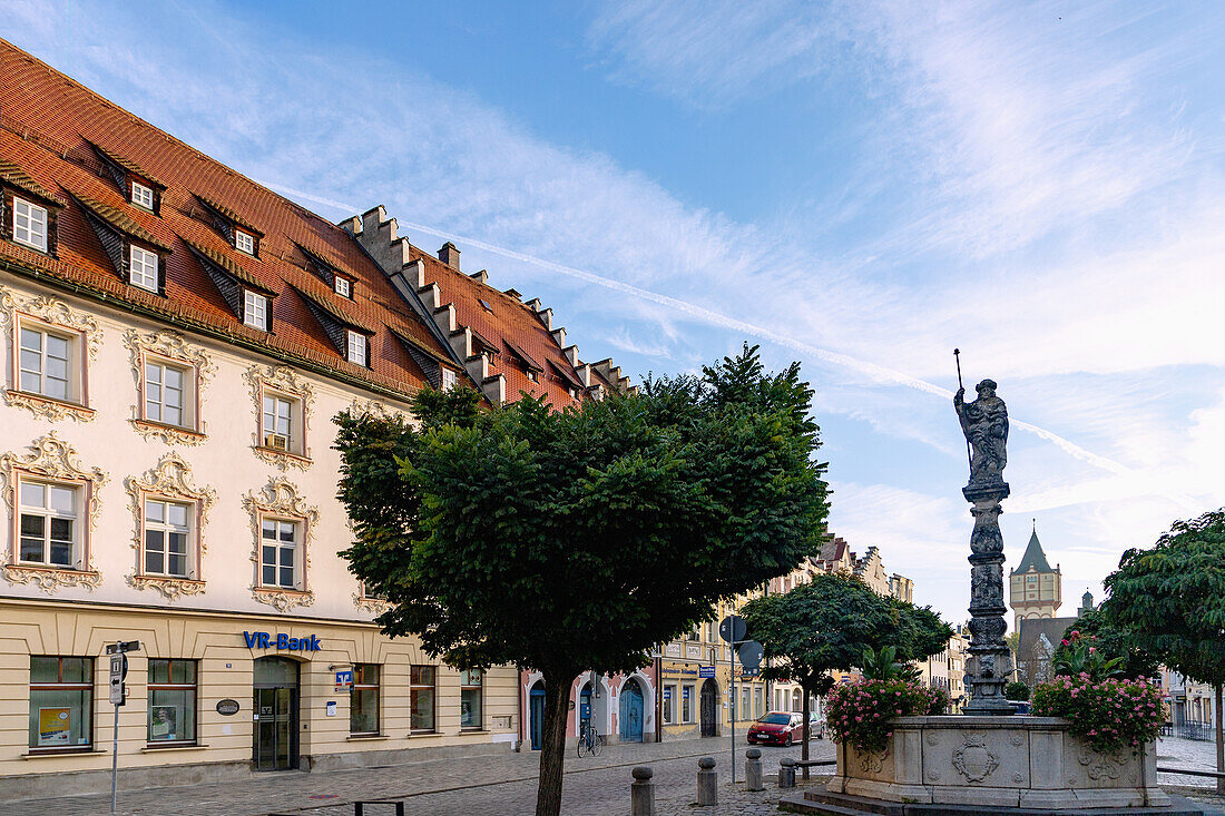 Ludwigsplatz with St. Jakobs fountain and the patrician house of the Zeller in der Kron and a view of the historic water tower in Straubing in Lower Bavaria in Germany