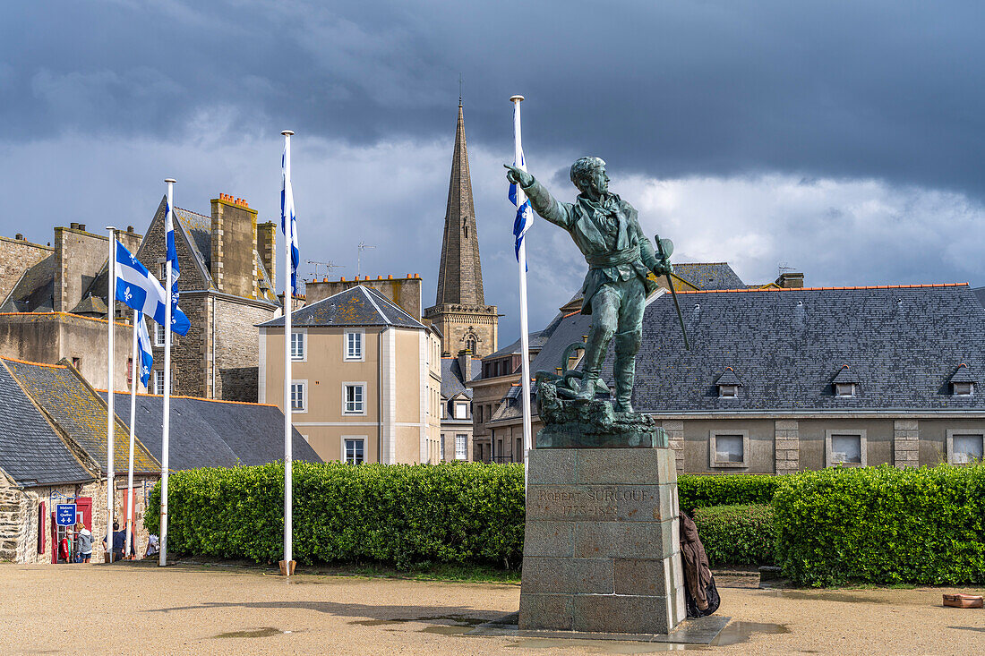 Statue of privateer Robert Surcouf in front of the old town with the tower of St Vincent Cathedral, Saint Malo, Brittany, France