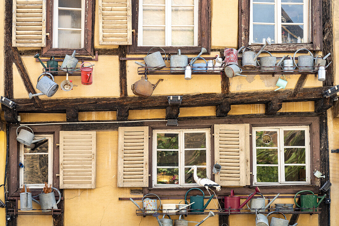 Half-timbered house decorated with watering cans in the old town of Colmar, Alsace, France