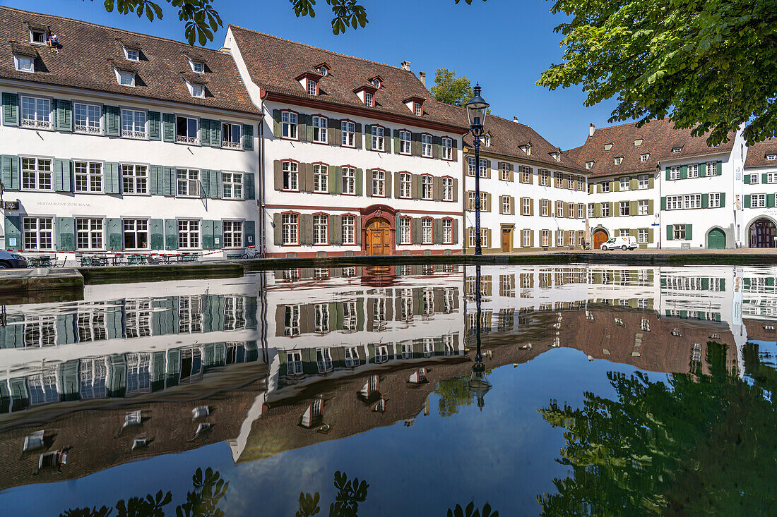 Minster square buildings reflected in a fountain, Basel, Switzerland, Europe