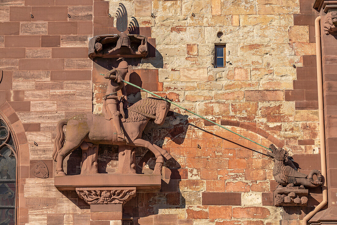 Saint George Killing the Dragon at the facade of the Basel Minster in Basel, Switzerland, Europe