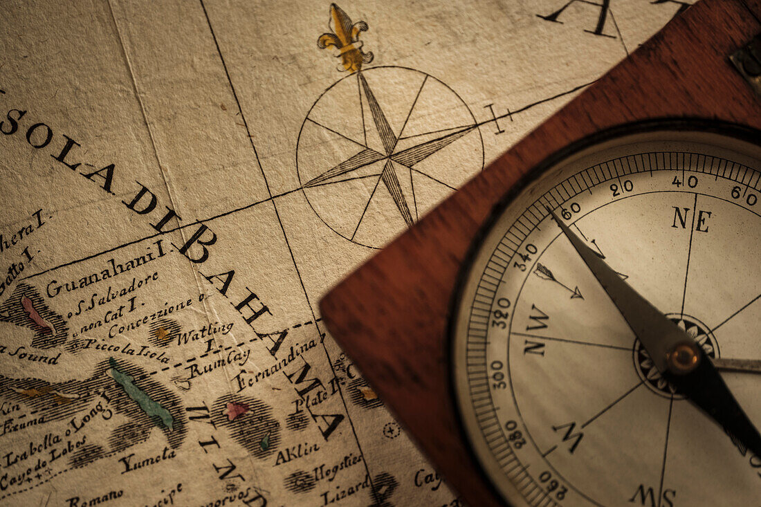 Antique compass on map