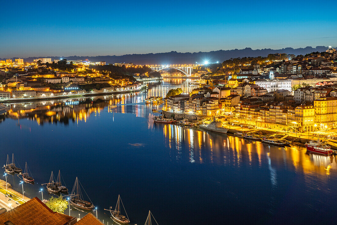 View across the Douro River to the old town of Porto and Vila Nova de Gaia at dusk, Portugal, Europe