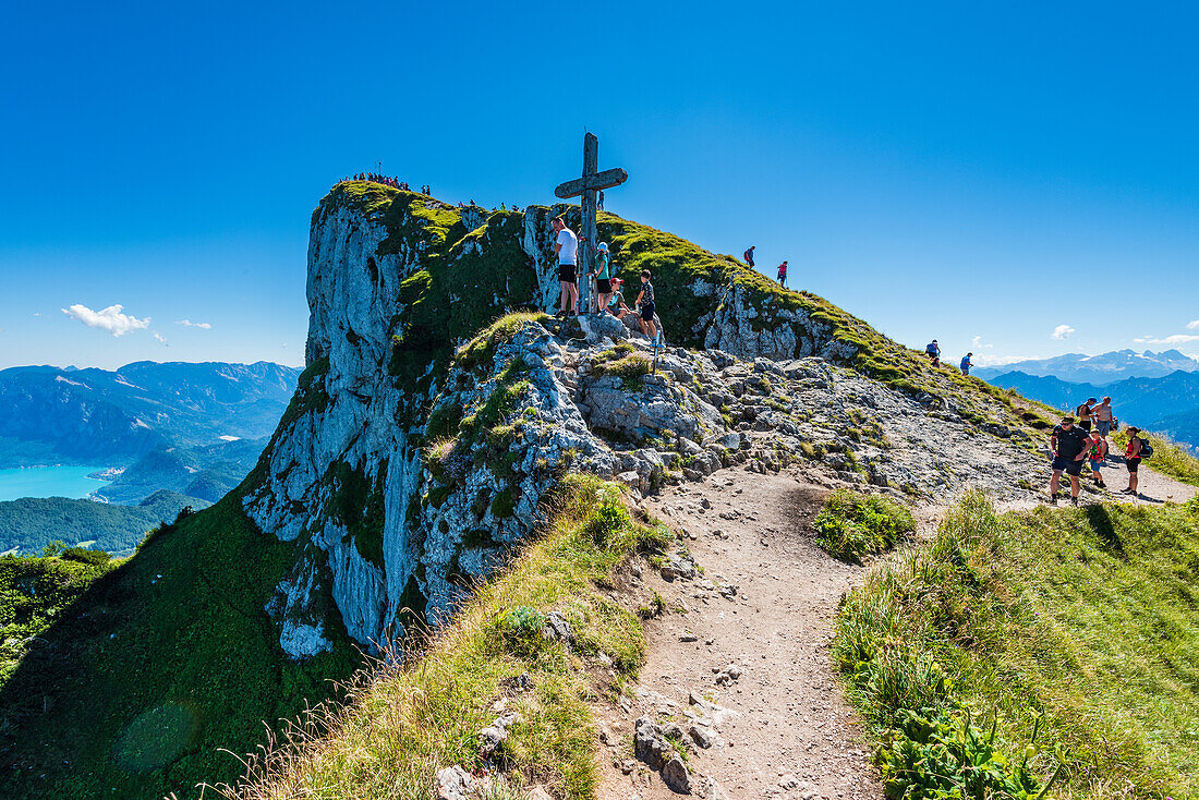 Summit cross and rock face on the Schafberg overlooking Lake Attersee and the Höllengebirge mountains, Salzkammergut, Austria