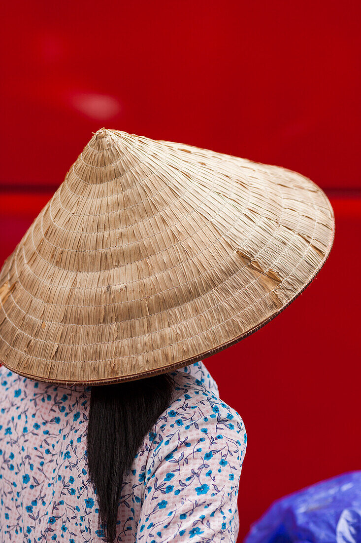 Vietnam, Hanoi. Woman wearing traditional hat