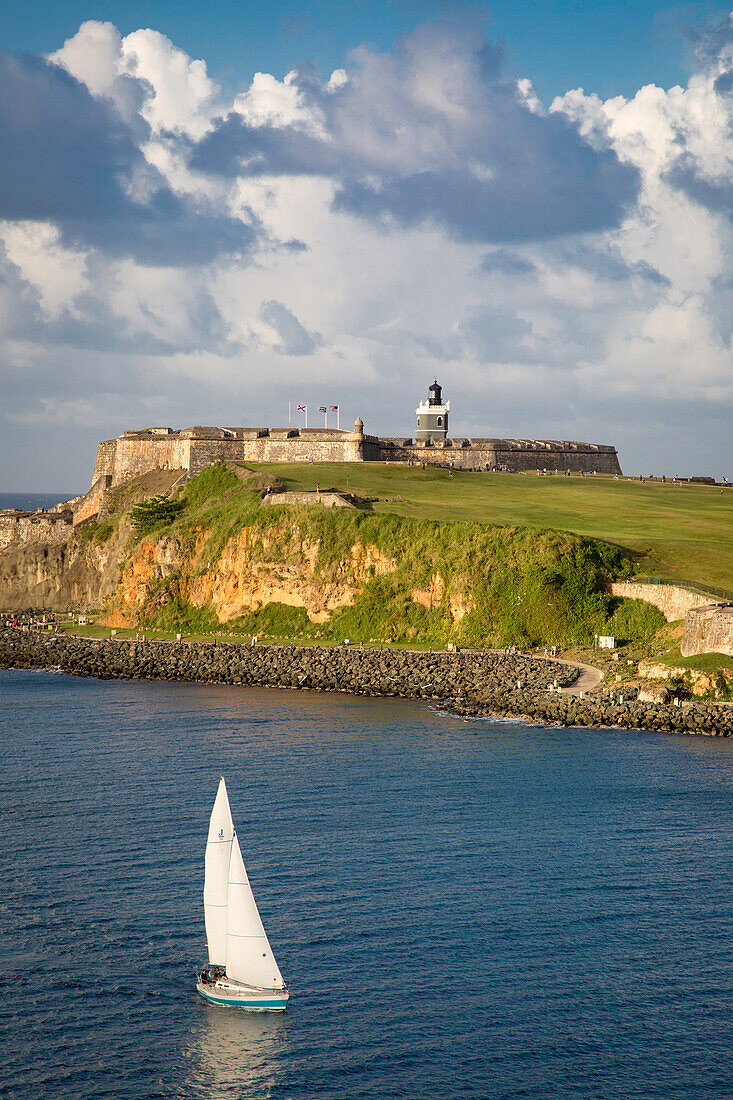 Sailboat below fortress El Morro, San Juan, Puerto Rico