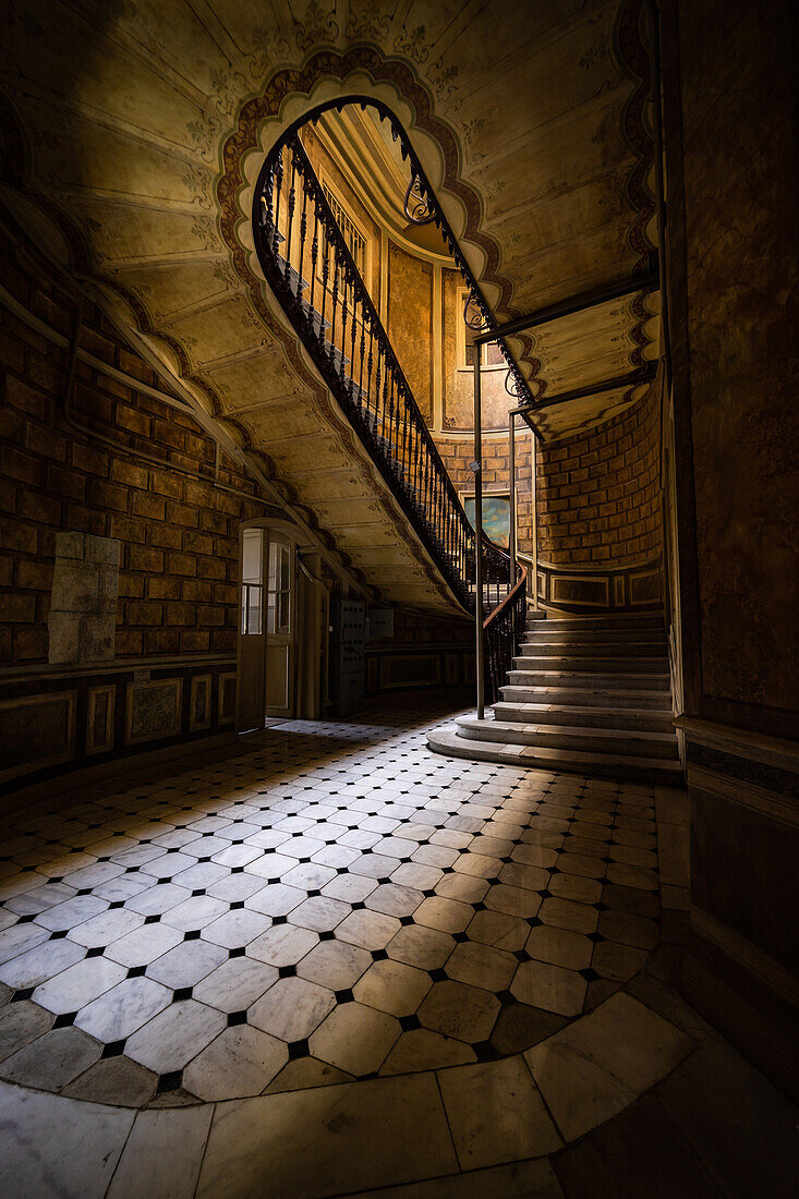 Interior of entrance hall with carved staircase in old maisons in Tbilisi's downtown, capital city of Georgia