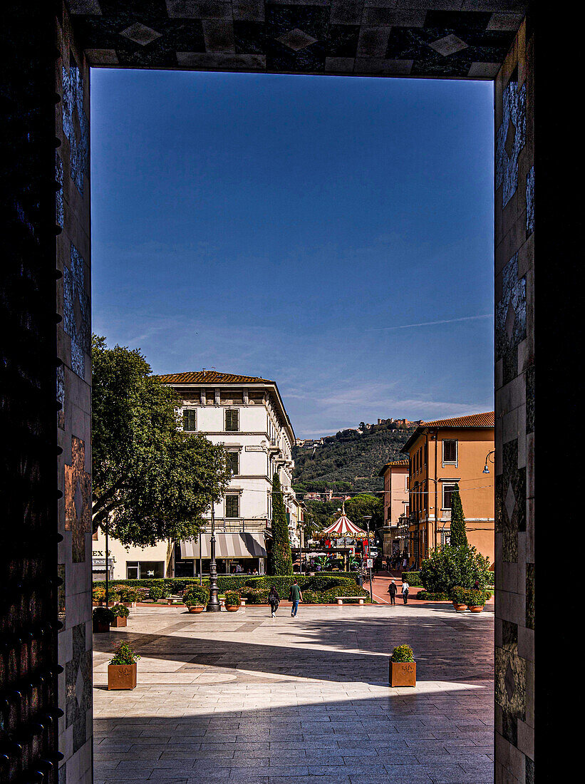 View from the portal of the Church of Santa Maria Assunta on the Piazza del Popolo to Viale Verdi, in the background the mountain village of Montecatini Alto, Montecatini Terme, Tuscany, Italy