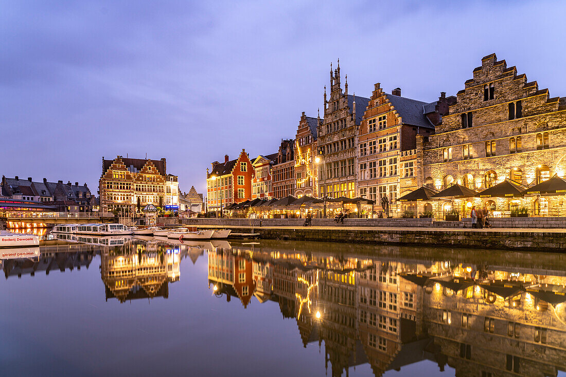 Medieval guild houses of the Graslei quay on the Leie river at dusk, Ghent, Belgium