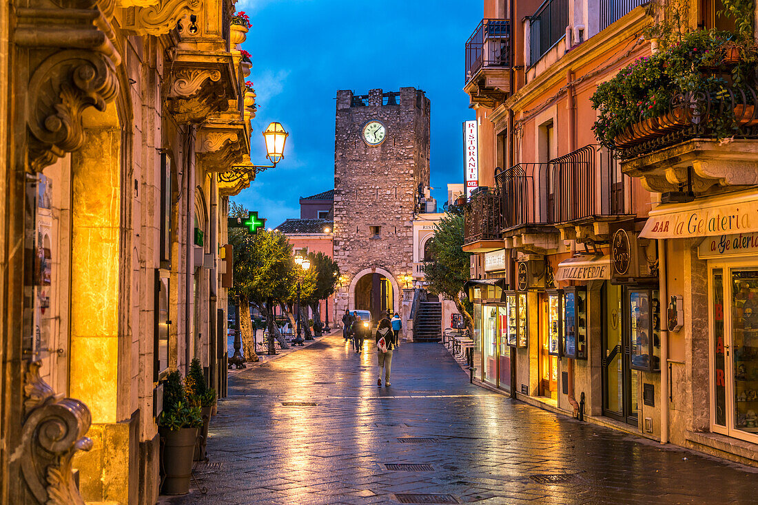 Pedestrian street Corso Umberto and the Torre dell'Orologio tower at dusk, Taormina, Sicily, Italy, Europe