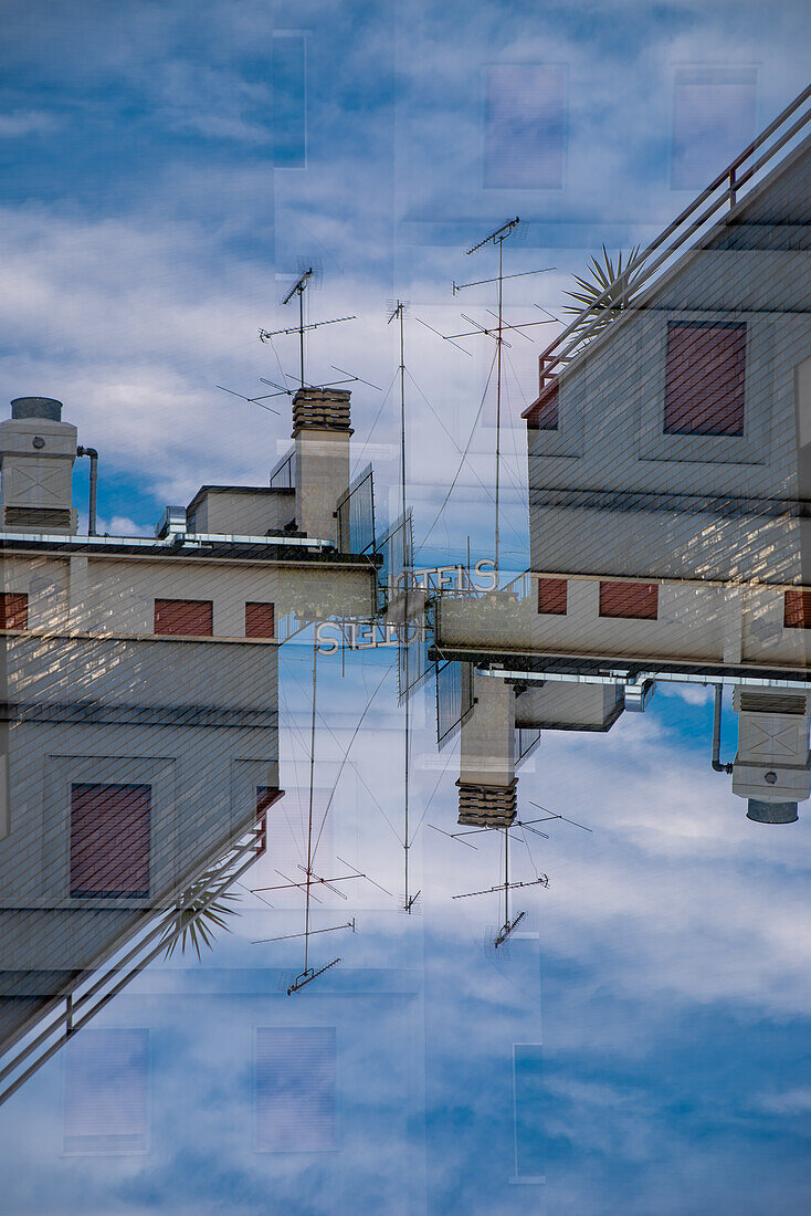 Double exposure photograph of the rooftops of Milan in the setting sun, Italy.