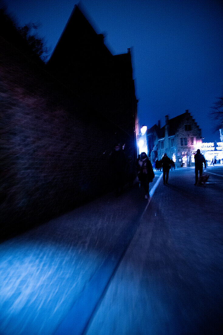 Nighttime wanderers in Bruges.