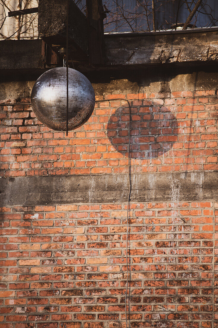 party mirrorball against red brick wall