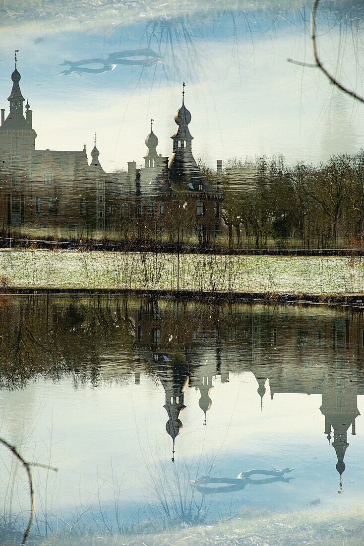 Double exposure of the fairytale castle of Ooidonk in the Ghent municipality in Belgium