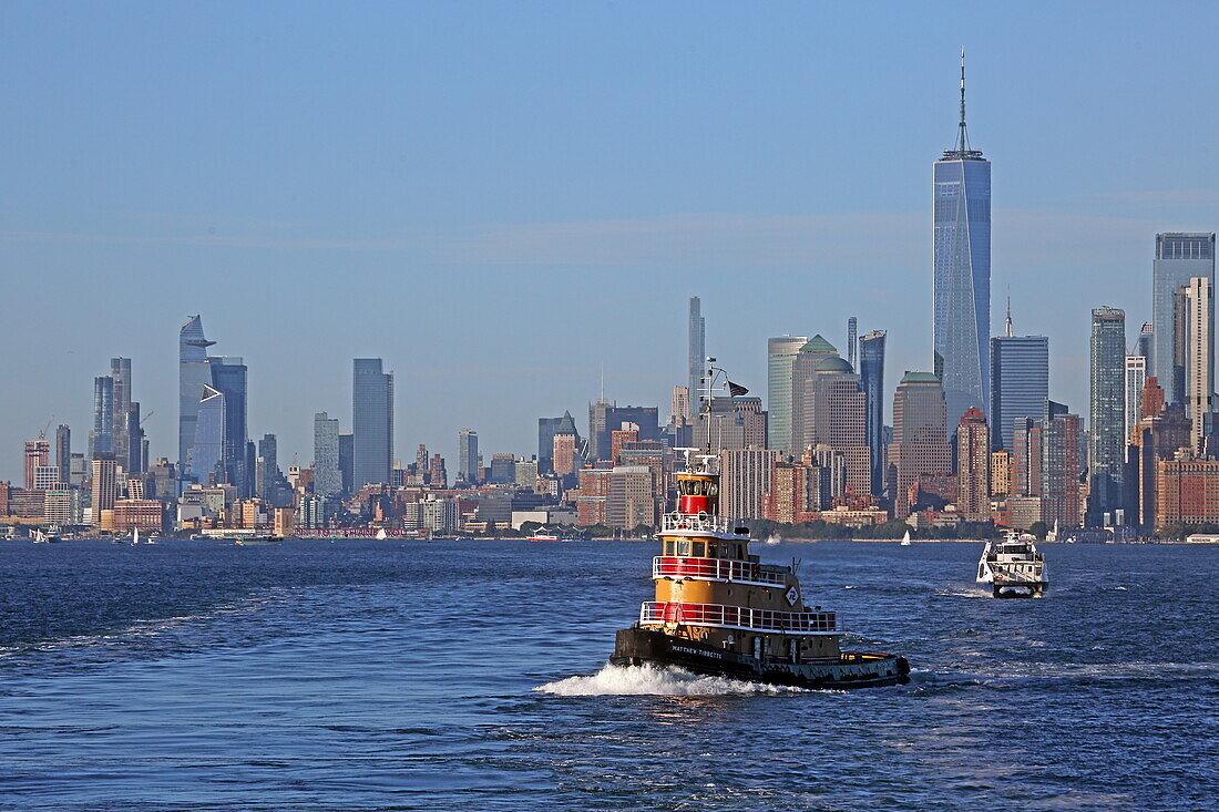 Tugboat in New York Harbor with the Financial District skyline and Hudson Yards to the left, Manhattan, New York, New York, USA