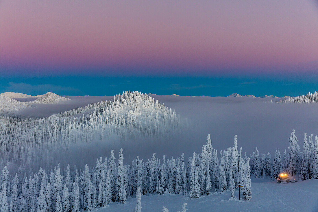 Groomer at dusk at Whitefish Mountain Resort in Whitefish, Montana, USA