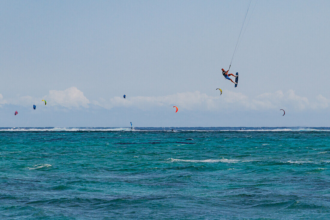A kitesurfer in flight far above the sea, Le Morne, Mauritius, Indian Ocean