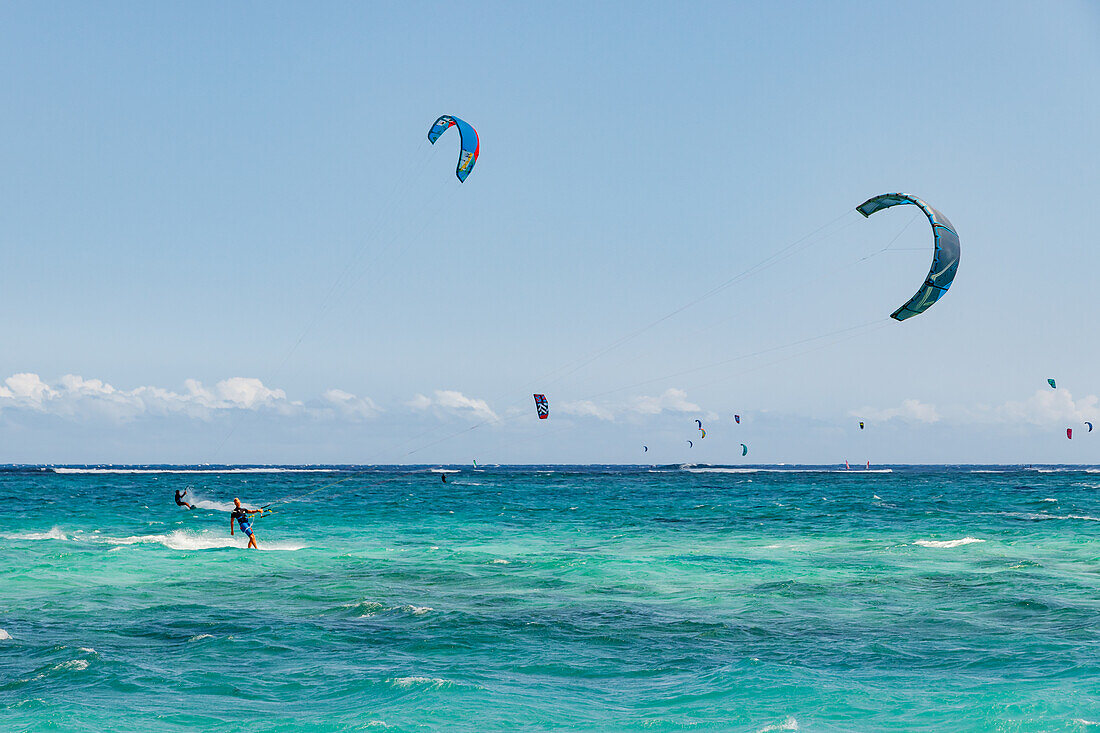 Lots of kitesurfers take advantage of the strong winds out at sea on the coast, Le Morne, Mauritius, Indian Ocean
