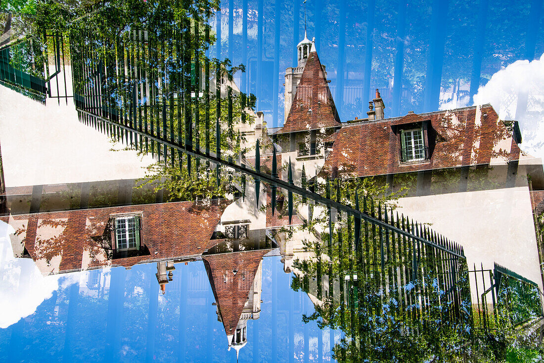 Double exposure of a residential building behind iron wrought fence in Paris, France.