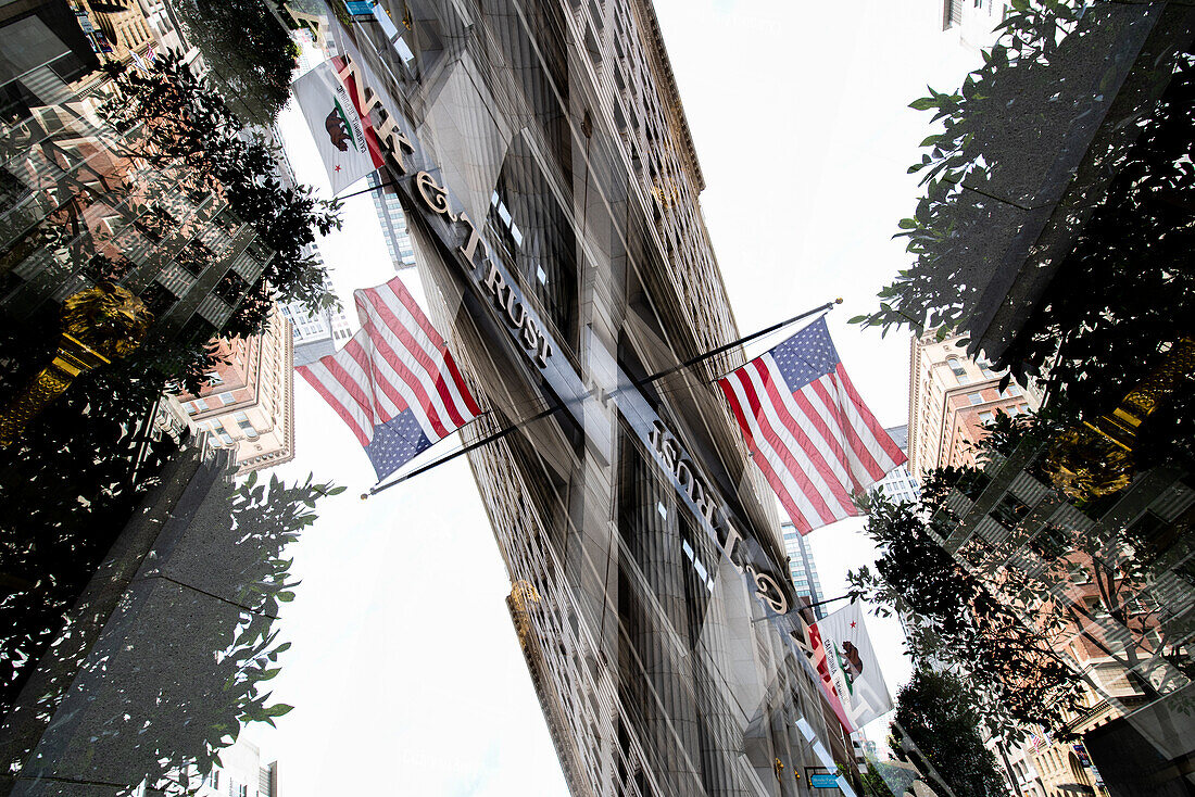 Double exposure of a building on California street featuring the American flag in the Financial District area of San Francisco, California.