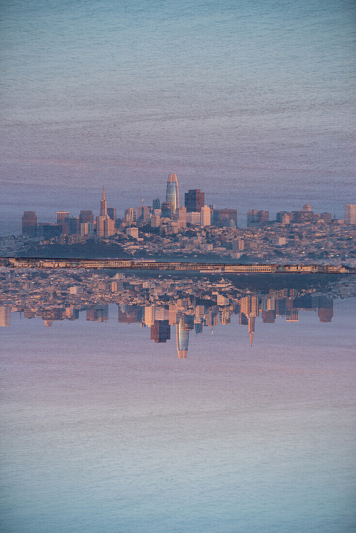 Skyline of San Francisco at dusk as seen from the North point of the Golden Gate Bridge.