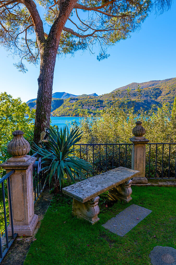 Stone Bench with View to Lombardy in Italy and Lake Lugano with Mountain and Blue Clear Sky From Morcote, Ticino, switzerland.
