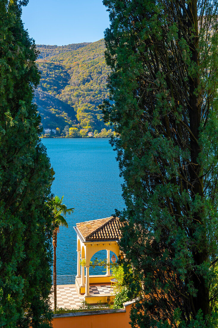 Patio on Lake Lugano with Mountain and Trees in a Sunny Day in Morcote, Ticino, Switzerland.