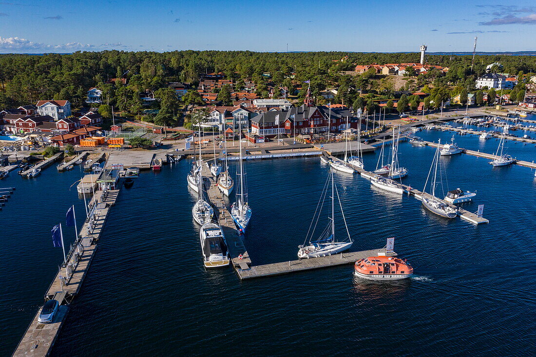 Aerial view of tender boat from expedition cruise ship World Voyager (nicko cruises) approaching marina, Sandhamn, Stockholm archipelago, Sweden, Europe