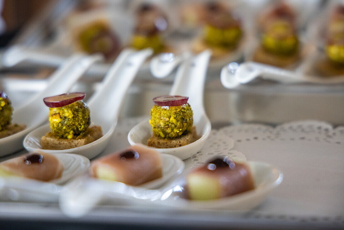 Canapés are served during the Captain's farewell reception in the Main Lounge aboard expedition cruise ship World Voyager (Nicko Cruises), at sea near the Azores, Portugal, Europe