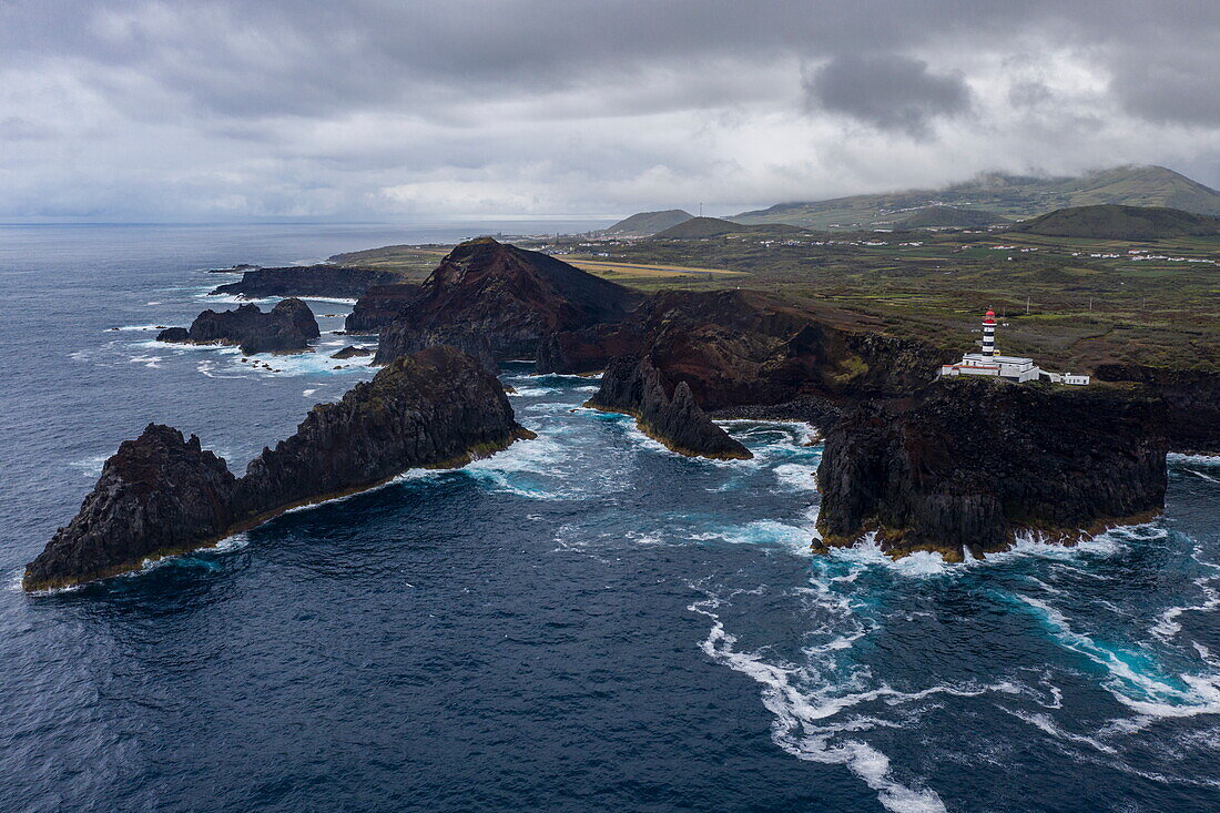 Aerial view of rugged coastline with Farol da Ponta da Barca lighthouse, Santa Cruz da Graciosa, Graciosa Island, Azores, Portugal, Europe