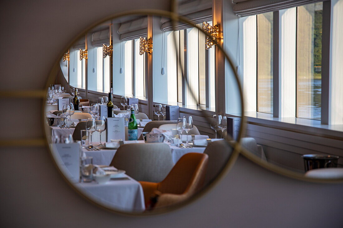 Reflection of the table decoration for the captain's dinner in the restaurant of river cruise ship Excellence Empress (travel agency Mittelthurgau) on the Danube, near Ybbs ad Donau, Wachau, Lower Austria, Austria, Europe