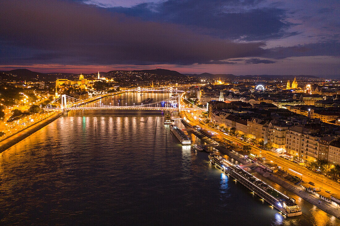 Aerial view from river cruise ship Excellence Empress (Mittelthurgau travel agency) overlooking Szechenyi Chain Bridge over Danube River and Fisherman's Bastion at night, Budapest, Pest, Hungary, Europe