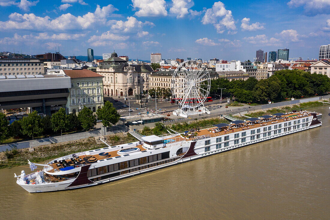 Aerial view of river cruise ship Excellence Empress (travel agency Mittelthurgau) docked on the Danube with the city behind, Bratislava, Bratislava, Slovakia, Europe