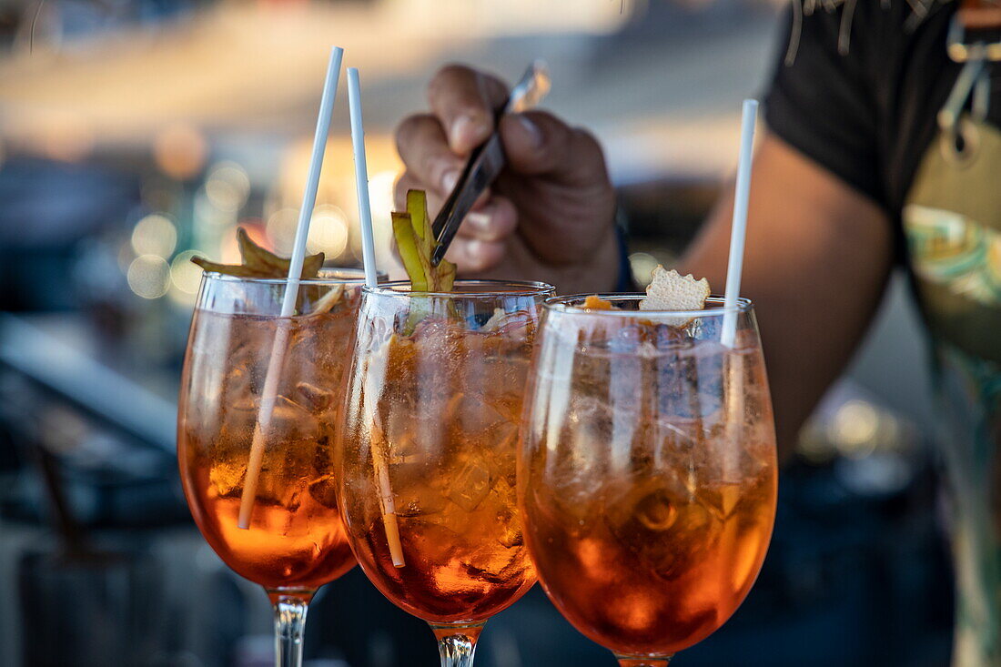 Detail of the Aperol Spritz cocktails being prepared at the 180º Sunset Bar on the hill overlooking the town and islands, Mykonos, South Aegean, Greece, Europe