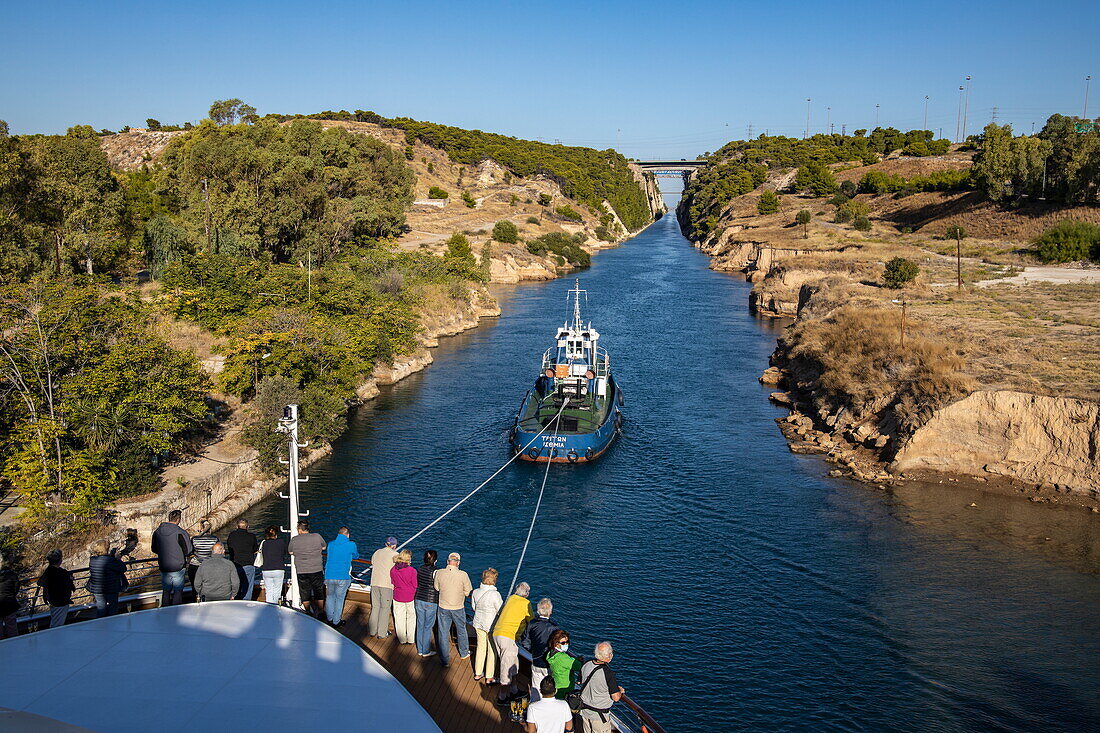 Tugboat assists expedition cruise ship World Explorer (Nicko Cruises) in passage of Corinth Canal, Isthmia, Peloponnese, Greece, Europe