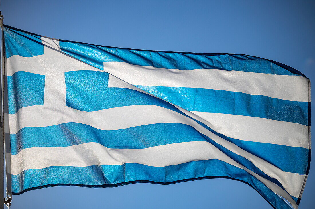 Greek national flag waving in the wind, Itea, Central Greece, Greece, Europe
