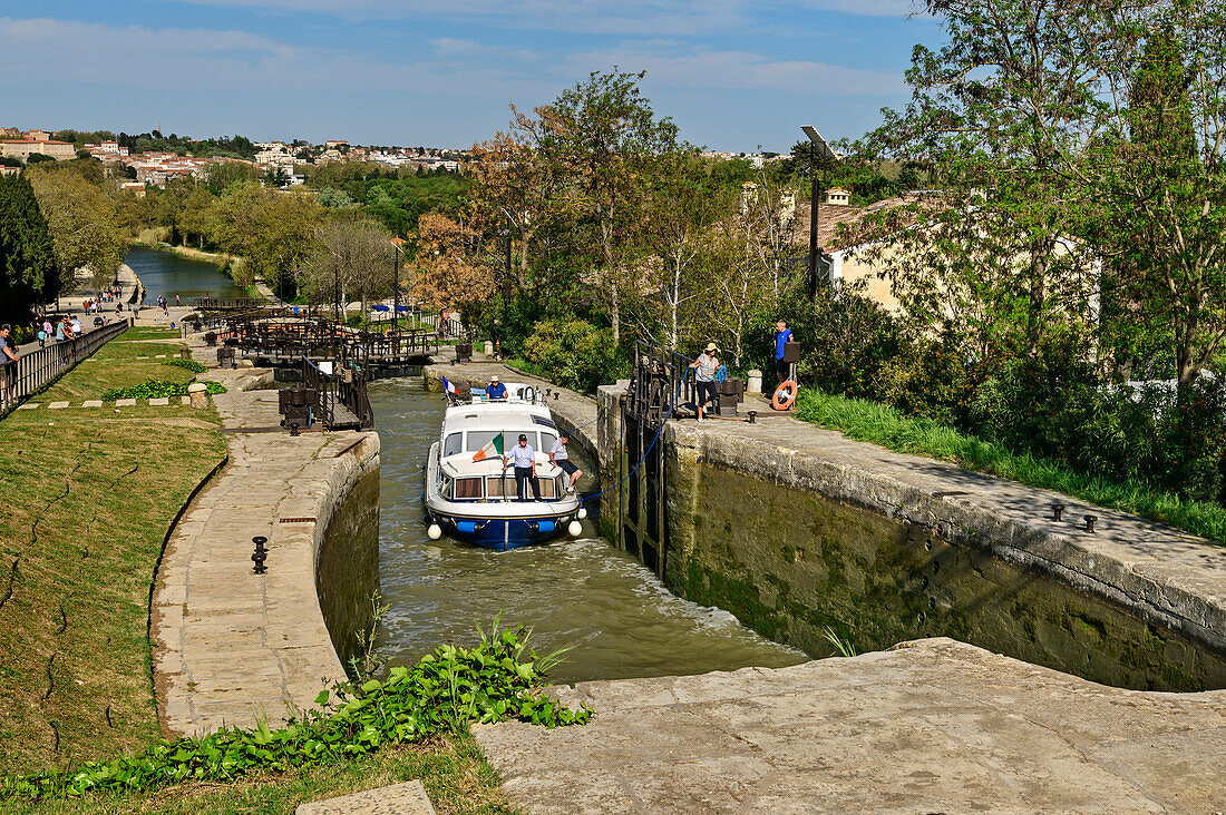 Boat going through Fonserannes lock staircase, Ecluses de Fonserannes, Canal du Midi, UNESCO World Heritage Canal du Midi, Occitania, France