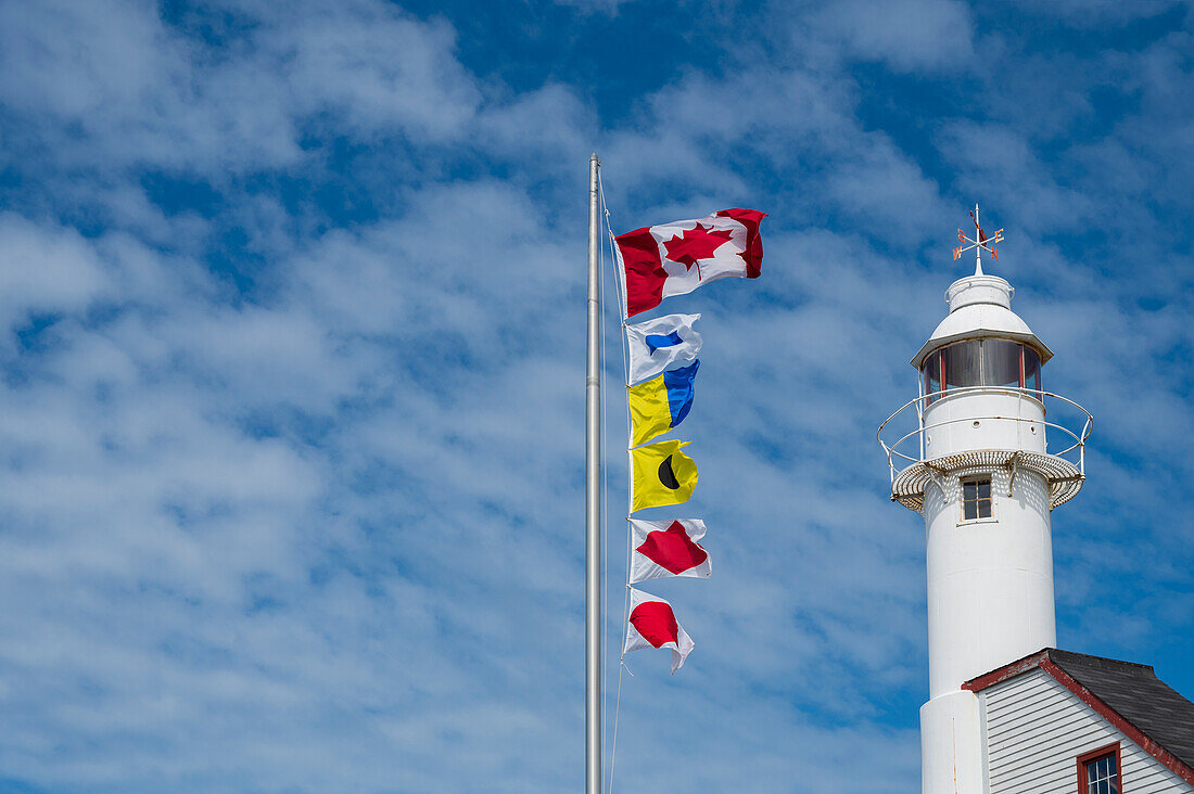 Canada, Labrador, Newfoundland, Rocky Harbor, Lobster Cove Head Lighthouse with waving flags