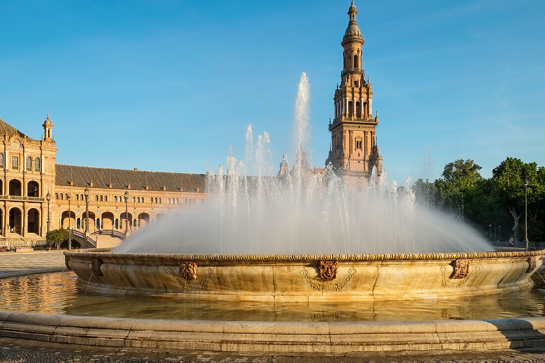 Spain, Seville, Fountain at Plaza de Espagna and church in background