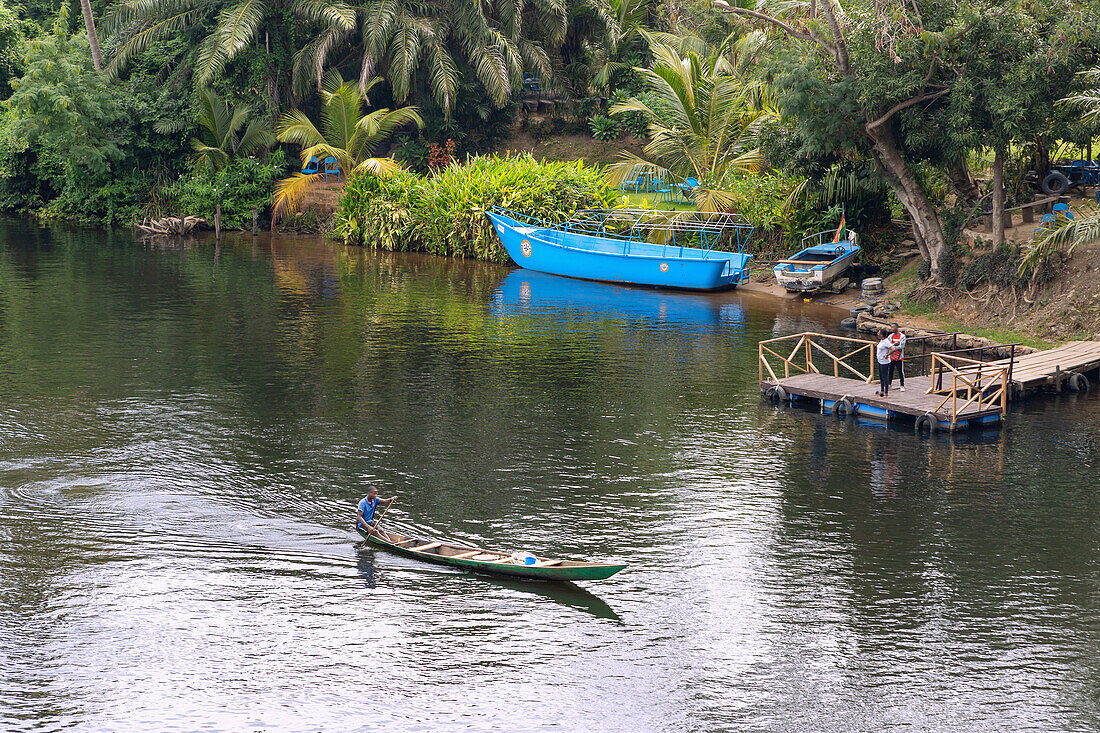 Fisherman in a pirogue on the Volta River, view from the Volta Bridge at Adomi near the Akosombo Dam in the Eastern Region of East Ghana in West Africa
